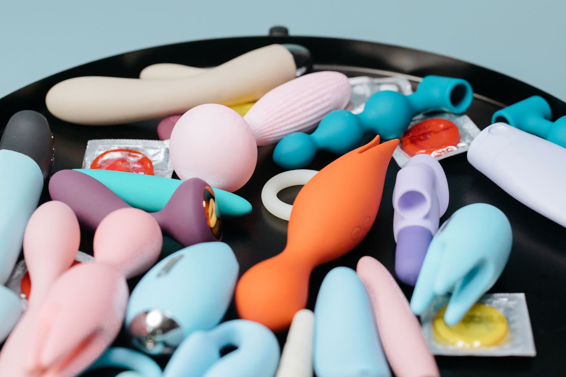 A vibrant collection of various lemon vibrators and sex toys on a black tray